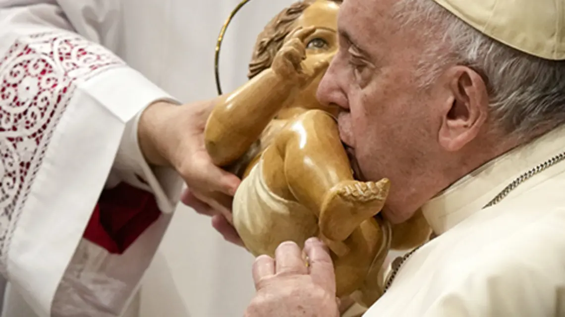 Papież całuje figurę Dzieciątka Jezus, przewodnicząc Mszy św. w uroczystość Objawienia Pańskiego w Watykanie, 6.01.2023 r. fot. AP Photo/Andrew Medichini/East News